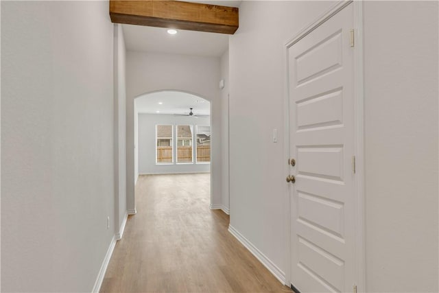 corridor with beamed ceiling and light hardwood / wood-style flooring