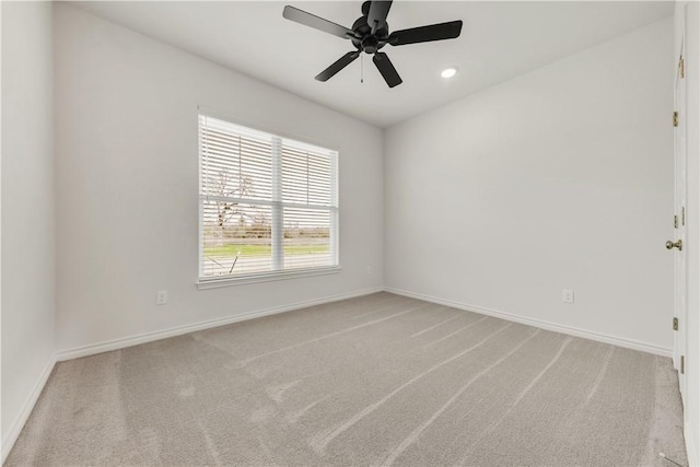 spare room with carpet floors and ceiling fan