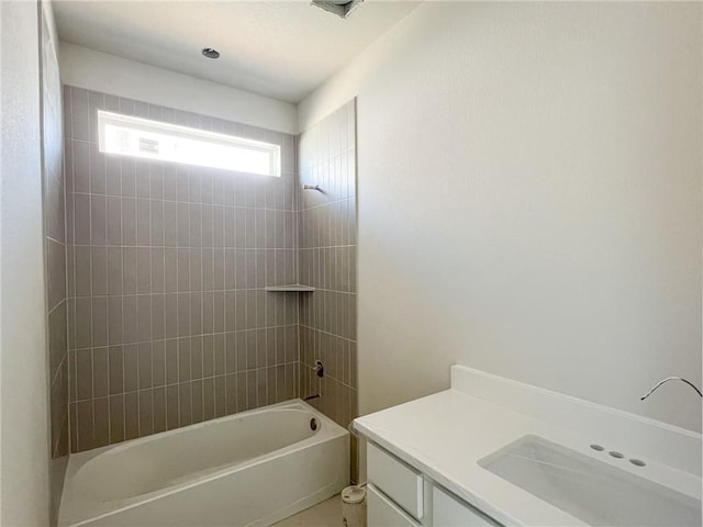 bathroom featuring vanity and tiled shower / bath combo