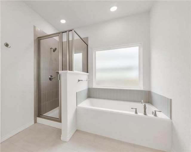 bathroom with tile patterned floors and separate shower and tub