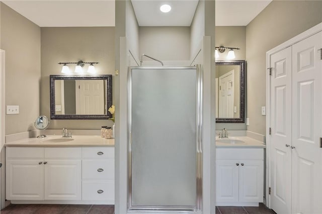 bathroom featuring vanity, tile patterned floors, and a shower with shower door