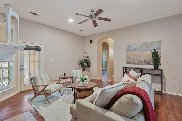 living room featuring dark hardwood / wood-style floors and ceiling fan