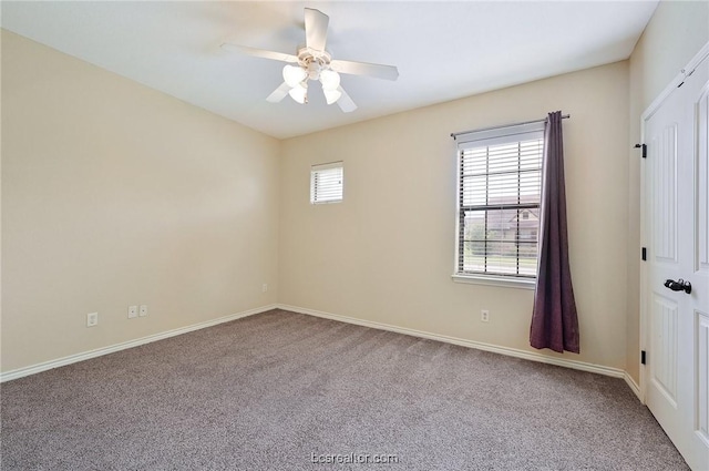 carpeted empty room featuring ceiling fan