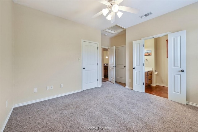 unfurnished bedroom featuring carpet floors, ceiling fan, and connected bathroom