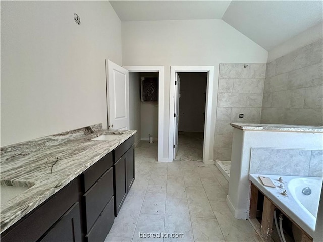 bathroom featuring tile patterned floors, vanity, shower with separate bathtub, and vaulted ceiling