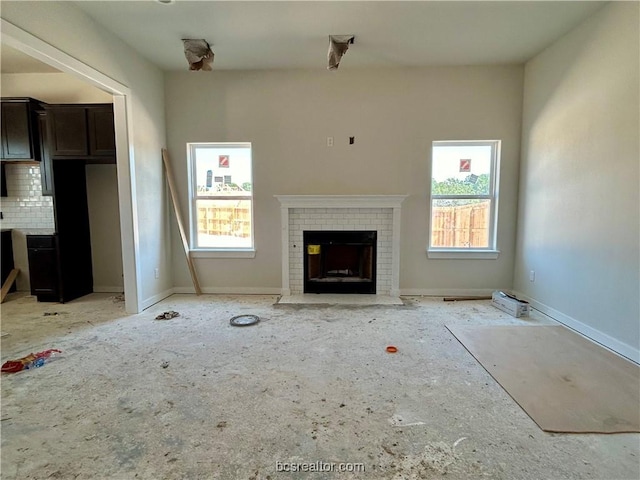 unfurnished living room with a brick fireplace