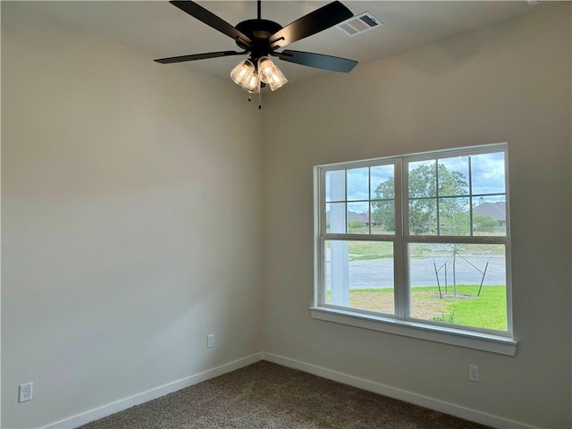 spare room with carpet flooring, ceiling fan, and a healthy amount of sunlight