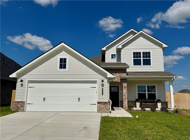 craftsman inspired home featuring a front lawn and a garage