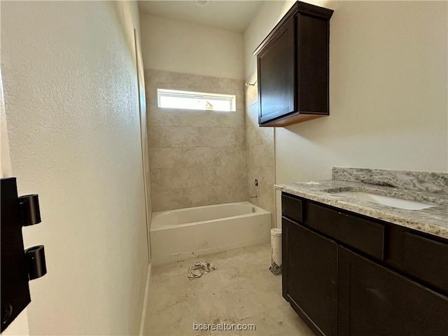 full bathroom featuring vanity, tiled shower / bath combo, and toilet