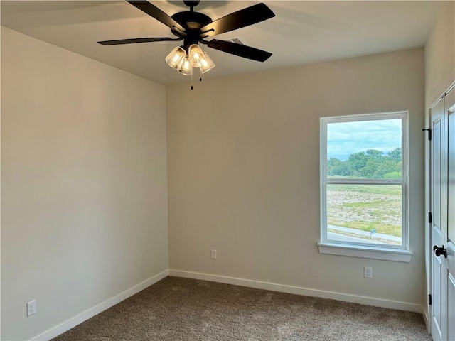 spare room with ceiling fan and carpet