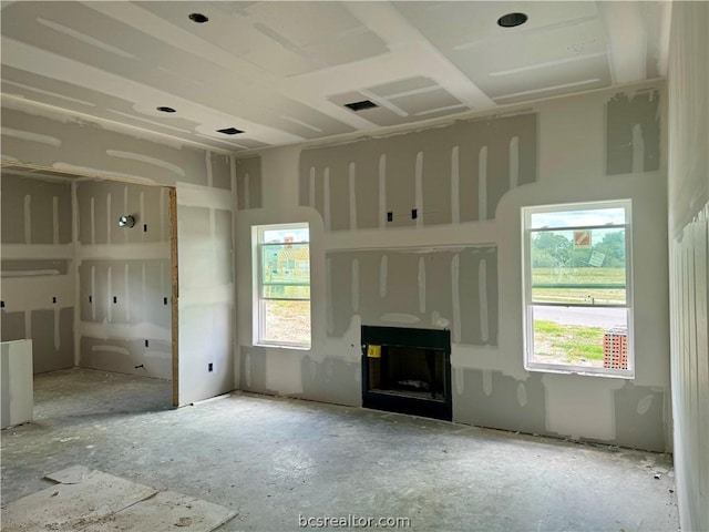 unfurnished living room featuring a fireplace and plenty of natural light