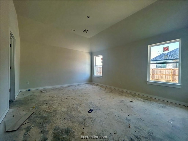 empty room with lofted ceiling