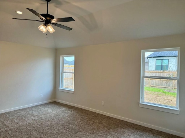 spare room with carpet flooring, ceiling fan, and a healthy amount of sunlight