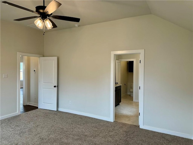 unfurnished bedroom featuring carpet floors, vaulted ceiling, and ceiling fan