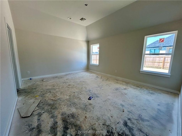 unfurnished room featuring lofted ceiling