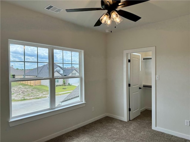 empty room with carpet floors and ceiling fan