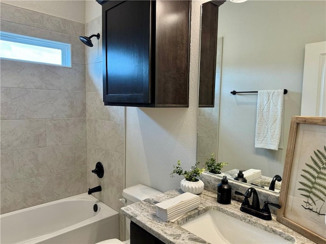 full bathroom with vanity, toilet, and tiled shower / bath