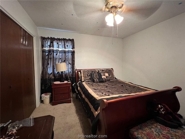 carpeted bedroom featuring a textured ceiling, a closet, and ceiling fan