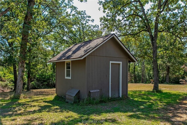 view of outdoor structure featuring a lawn