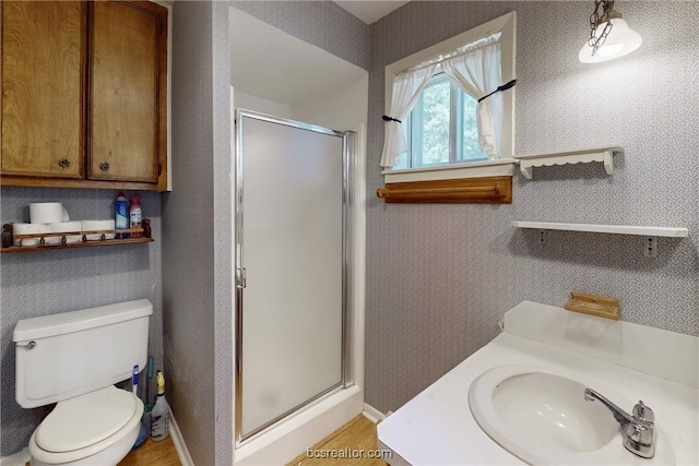 bathroom with toilet, sink, and walk in shower