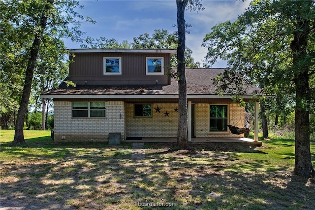 rear view of property featuring a yard and a patio