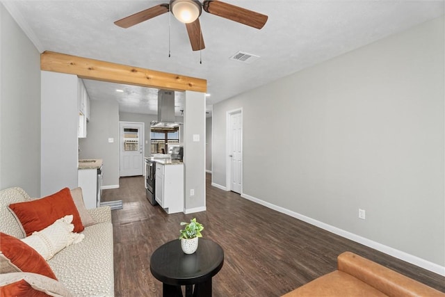 living room featuring ceiling fan and dark wood-type flooring