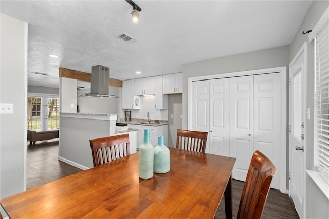 dining area featuring dark hardwood / wood-style floors and sink