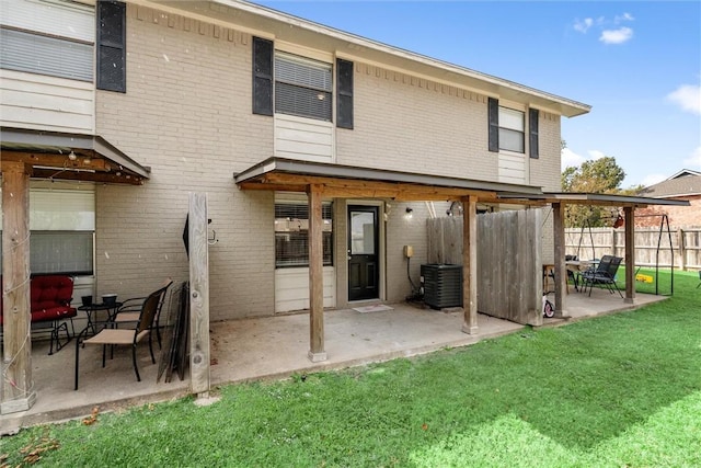 back of property with cooling unit and a yard