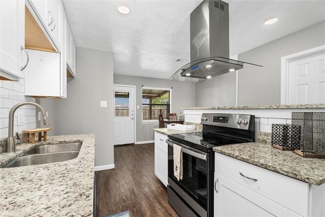 kitchen featuring electric range, island range hood, white cabinetry, and sink