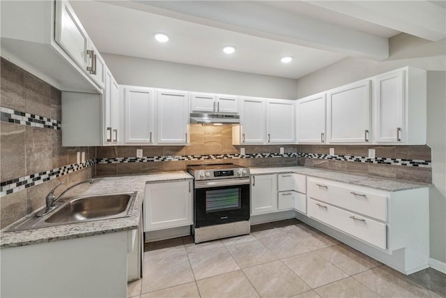 615 San Jacinto Ln, Bryan, TX 77803 - kitchen featuring stainless steel electric stove, under cabinet range hood, backsplash, light tile patterned flooring, and beam ceiling