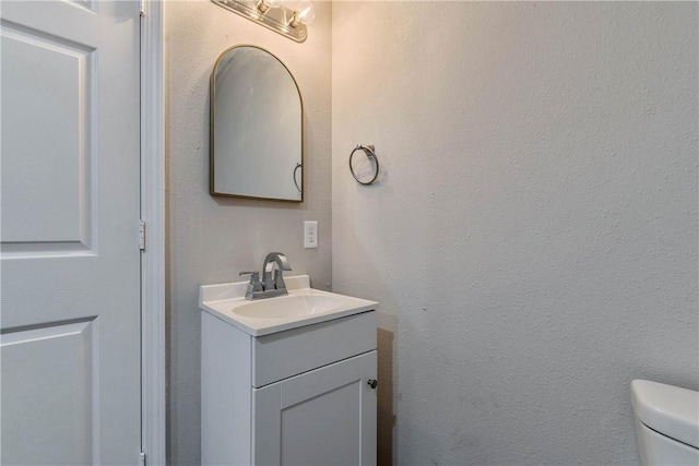 615 San Jacinto Ln, Bryan, TX 77803 - half bathroom featuring vanity and toilet