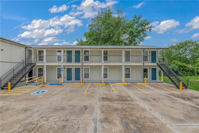 615 San Jacinto Ln, Bryan, TX 77803 - view of building exterior featuring stairs and uncovered parking
