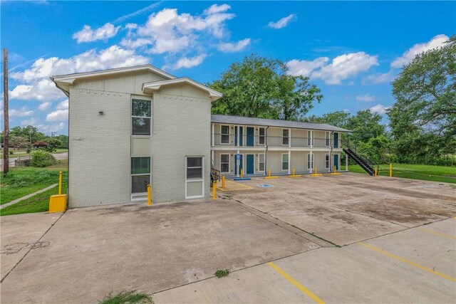 615 San Jacinto Ln, Bryan, TX 77803 - view of building exterior with uncovered parking and stairway