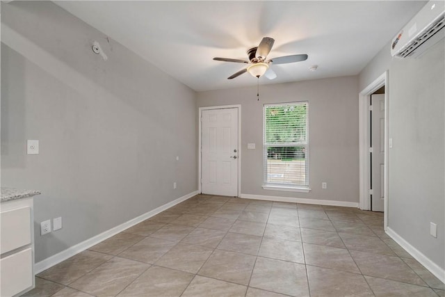 615 San Jacinto Ln, Bryan, TX 77803 - spare room featuring a wall mounted air conditioner, a ceiling fan, and light tile patterned floors
