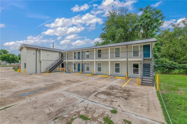 615 San Jacinto Ln, Bryan, TX 77803 - view of property featuring stairway and uncovered parking