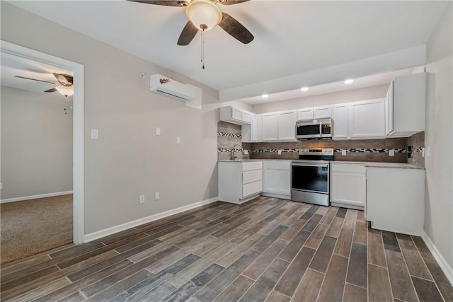 615 San Jacinto Ln, Bryan, TX 77803 - kitchen featuring appliances with stainless steel finishes, ceiling fan, an AC wall unit, recessed lighting, and backsplash