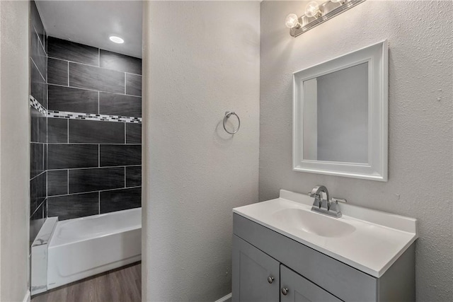 615 San Jacinto Ln, Bryan, TX 77803 - full bathroom featuring vanity, wood finished floors, and shower / bathtub combination