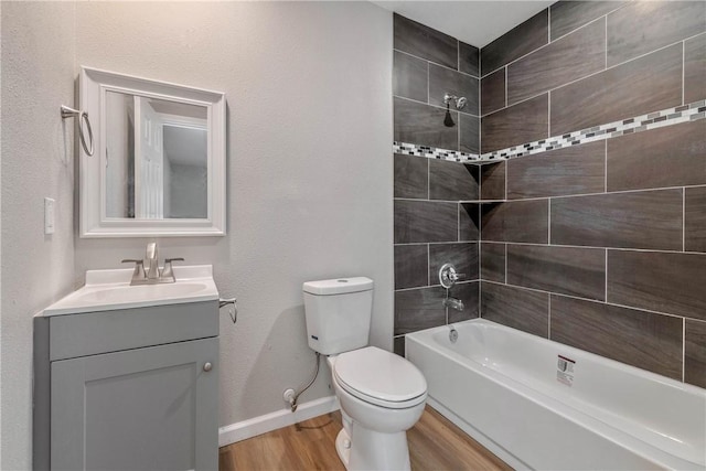 615 San Jacinto Ln, Bryan, TX 77803 - bathroom with wood finished floors, vanity, and washtub / shower combination