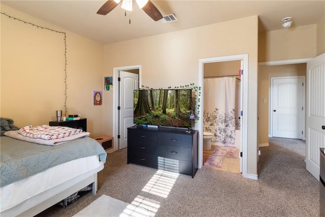 carpeted bedroom featuring connected bathroom and ceiling fan