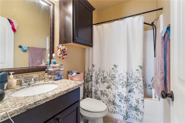 full bathroom with vanity, shower / tub combo, and toilet