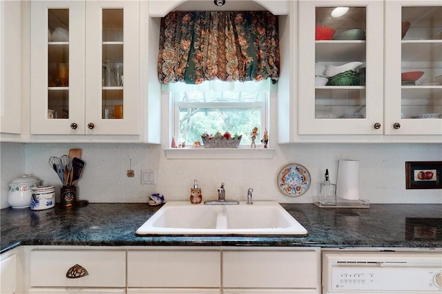 kitchen featuring backsplash, white cabinetry, sink, and white dishwasher