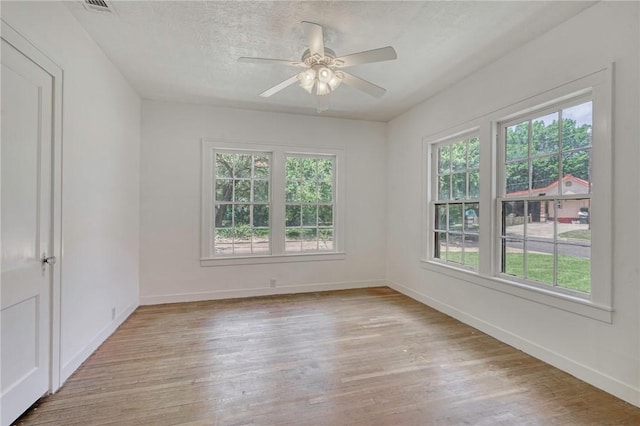 409 N Hutchins St, Bryan, TX 77803 - empty room featuring light wood finished floors, a ceiling fan, and a textured ceiling