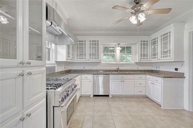 409 N Hutchins St, Bryan, TX 77803 - kitchen featuring appliances with stainless steel finishes, ventilation hood, white cabinetry, a ceiling fan, and glass insert cabinets
