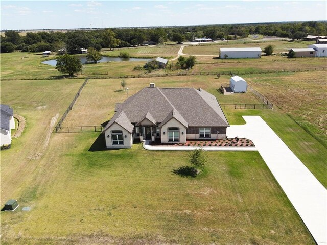 birds eye view of property with a water view and a rural view