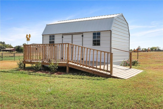 back of house featuring a yard and a deck