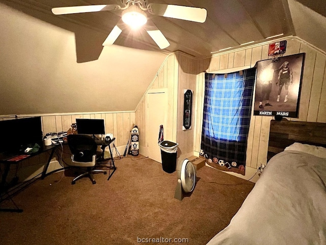 carpeted office space with ceiling fan, wood walls, and lofted ceiling