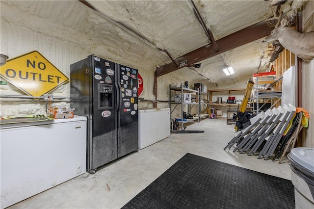 basement featuring washer / clothes dryer, black refrigerator with ice dispenser, and refrigerator