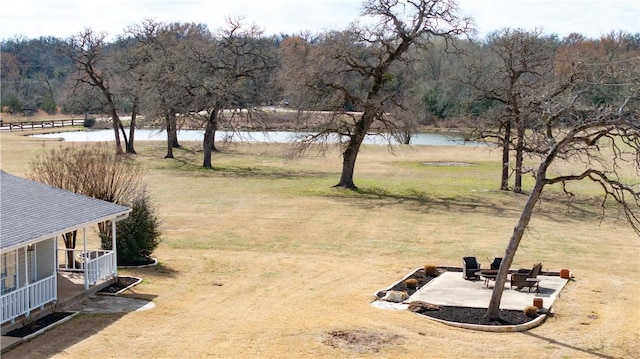 view of yard featuring a patio area and a water view