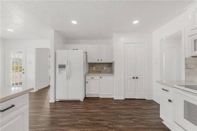 kitchen featuring white cabinetry, white appliances, dark hardwood / wood-style flooring, and tasteful backsplash