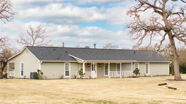 view of front facade with a porch, central AC unit, and a front lawn